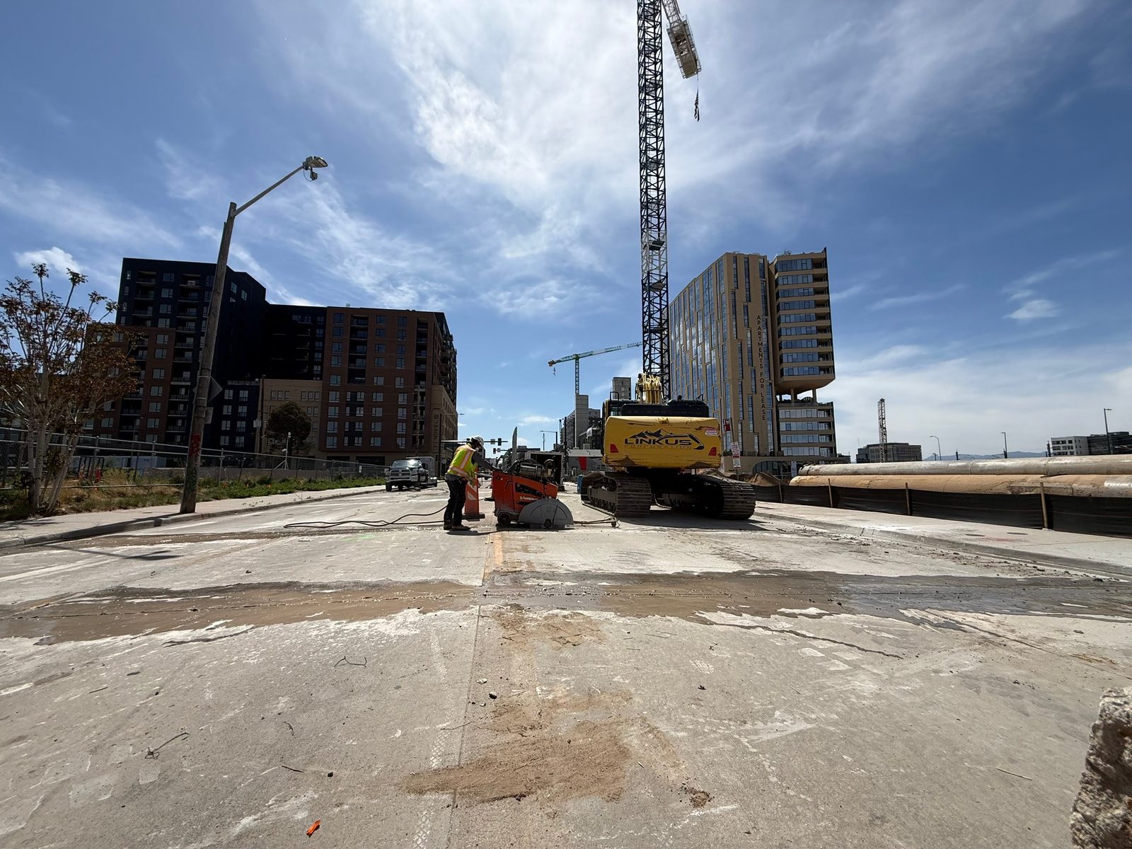 Sawn road panel being removed on a downtown Denver street for a civil contractor's sewer line replacement
