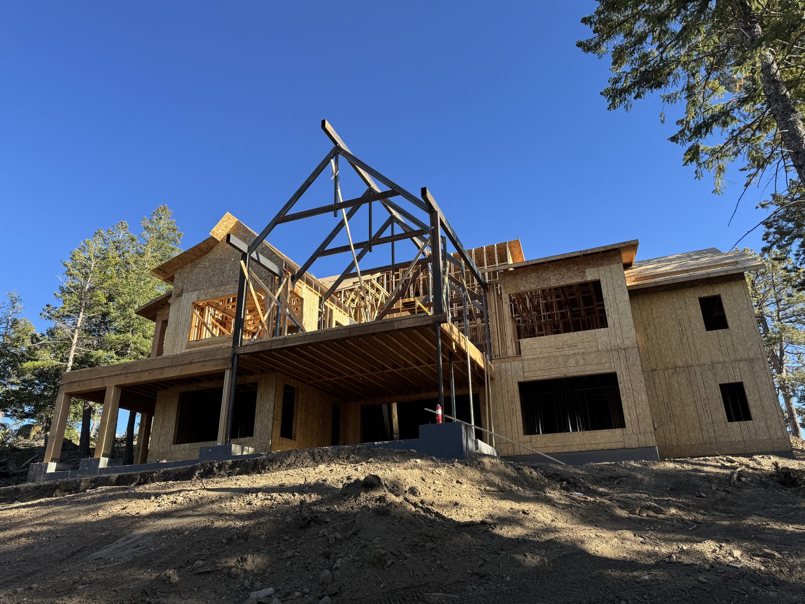 Custom steel joists fabricated by Conrad, craned over an entire house from the street side and set into place
